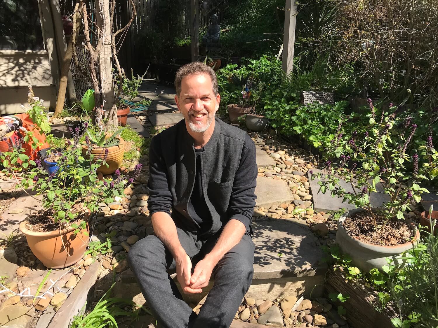Dr. Marc Cohen sitting in his garden