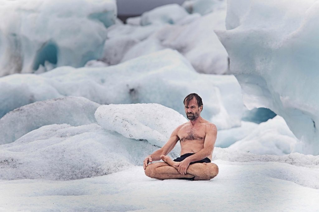 Wim Hof sitting bare-chested on ice